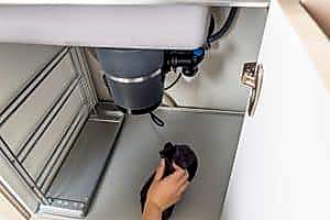 Image presents Why might your garbage disposal overheat or become jammed