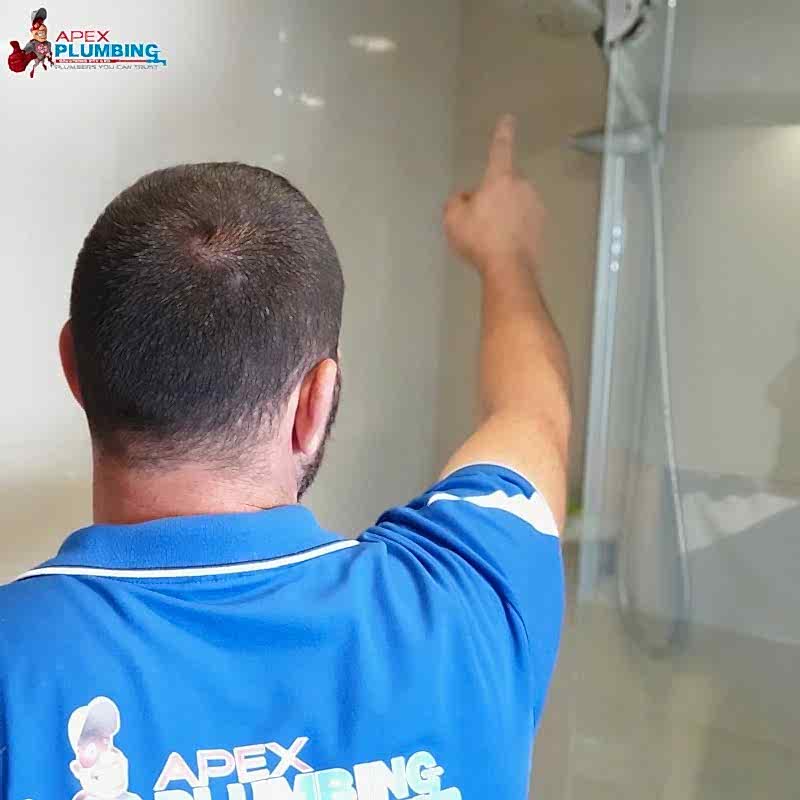 a hot water System repairs expert pointing a shower on the bathroom
