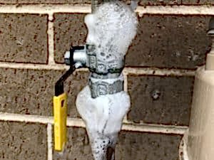 Close-up of a gas valve with soap test for leaks, complying with gas installation regulations.