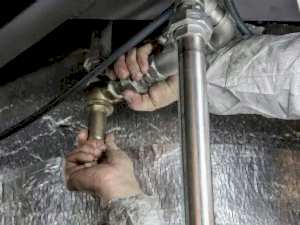 a plumber fixing a type of pipe to maintain its function