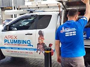 A plumbing vehicle showing tools for addressing tree roots in drainage pipes with professional plumbing services contact details.